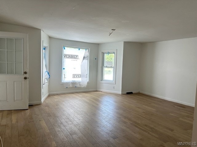 unfurnished room with dark hardwood / wood-style floors