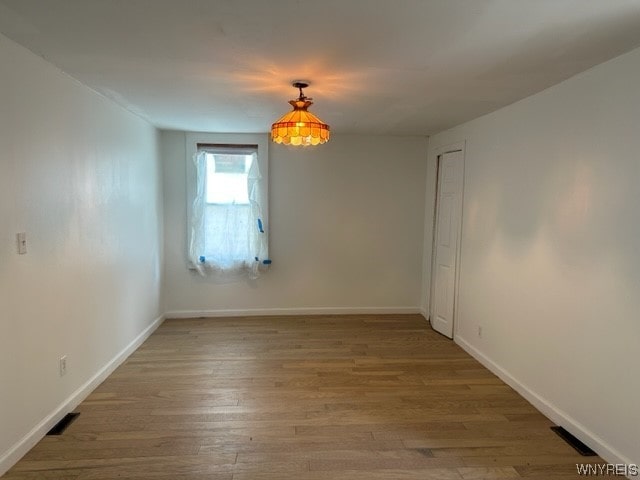 empty room with dark hardwood / wood-style floors