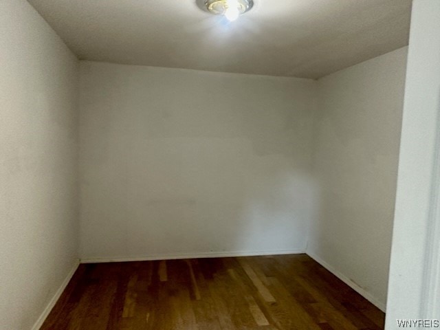 unfurnished room with dark hardwood / wood-style floors