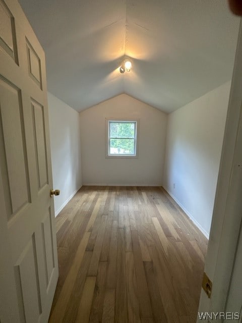 bonus room featuring hardwood / wood-style flooring and vaulted ceiling