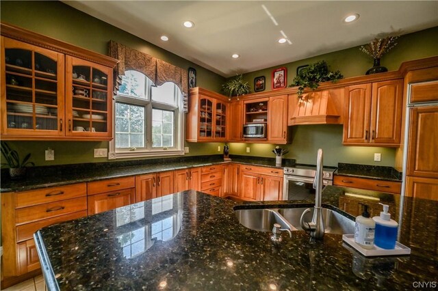 kitchen featuring dark stone countertops and appliances with stainless steel finishes