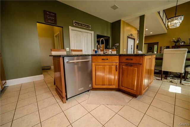 kitchen featuring an island with sink, dishwasher, light tile patterned floors, and a chandelier