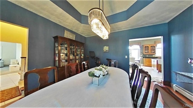 tiled dining space with baseboard heating and an inviting chandelier