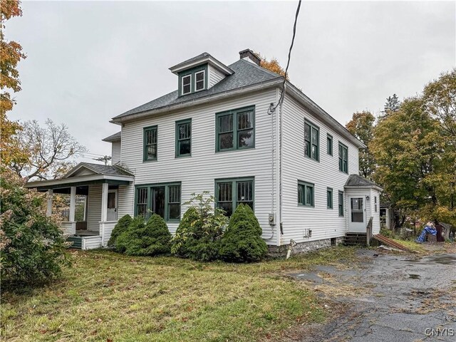 12 Academy St, Antwerp, NY 13608 - view of front of property with a chimney, entry steps, a front lawn, and roof with shingles