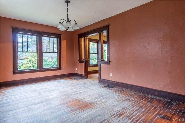 12 Academy St, Antwerp, NY 13608 - empty room with wood-type flooring, a chandelier, and baseboards