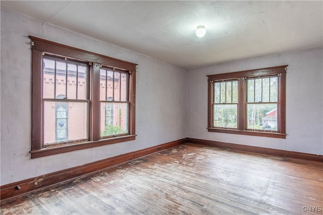 unfurnished room with hardwood / wood-style floors