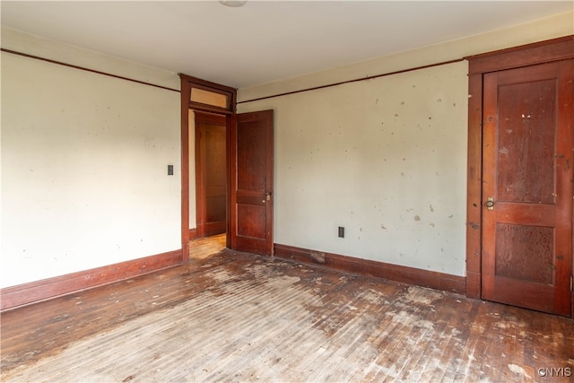 unfurnished room with dark wood-type flooring