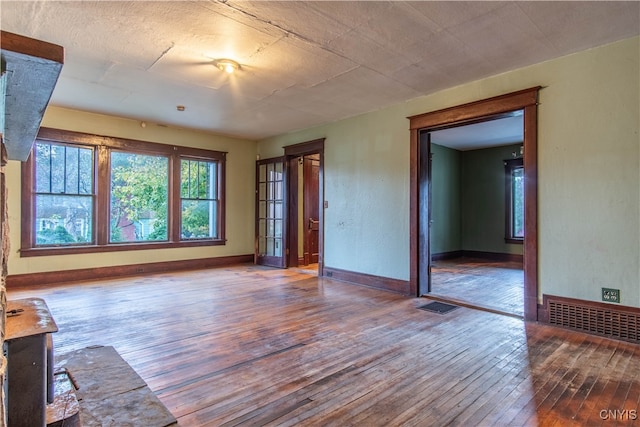 unfurnished living room featuring hardwood / wood-style flooring