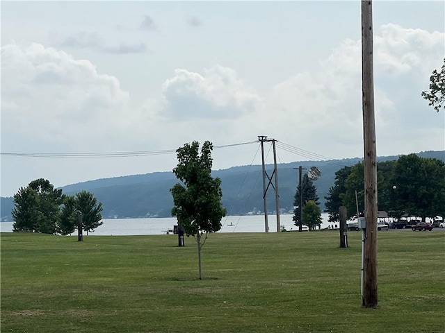 exterior space with a yard and a water and mountain view