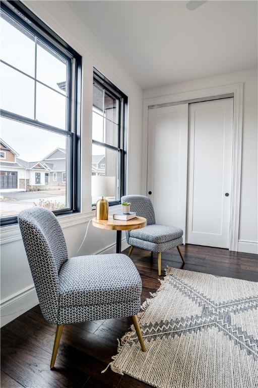 sitting room with dark wood-type flooring