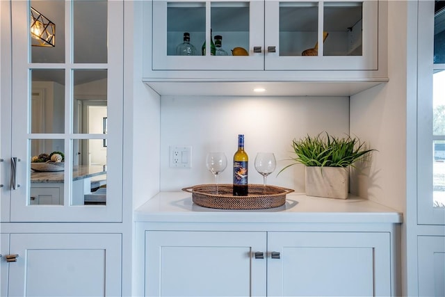 bar featuring white cabinetry