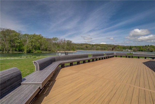 wooden terrace featuring a water view