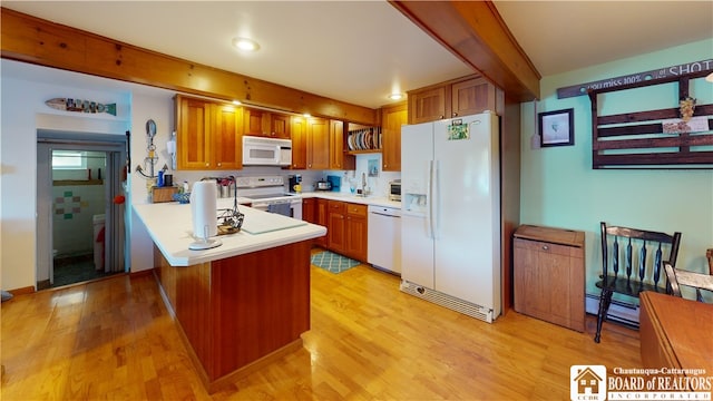 kitchen featuring white appliances and light wood-type flooring