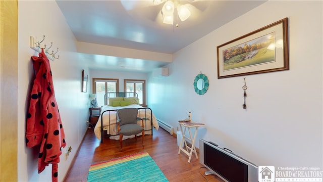 bedroom featuring a baseboard radiator, ceiling fan, and dark hardwood / wood-style floors