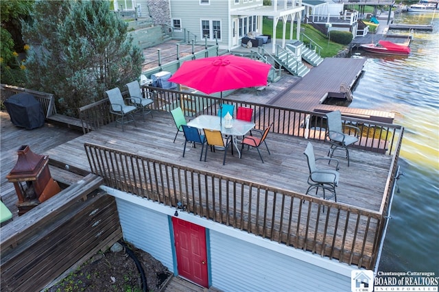 wooden deck featuring a water view and a dock