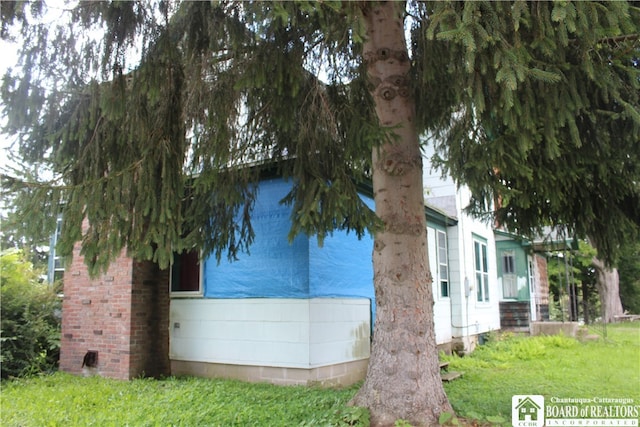 view of side of home featuring a yard