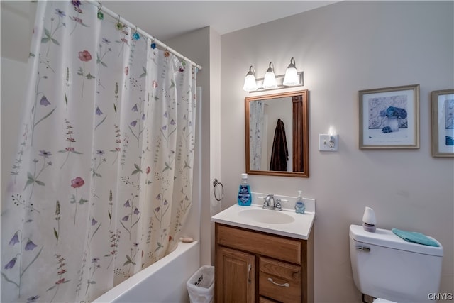 full bathroom featuring toilet, vanity with extensive cabinet space, and shower / tub combo with curtain