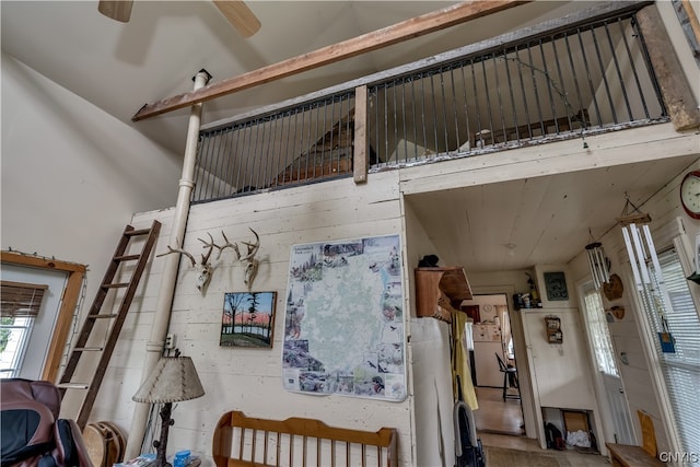 interior space with ceiling fan and a towering ceiling