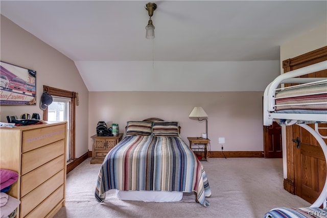 carpeted bedroom featuring lofted ceiling