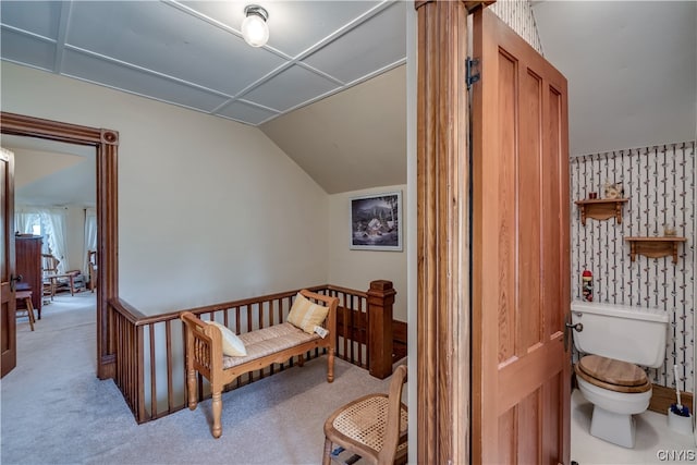 interior space featuring lofted ceiling and light colored carpet