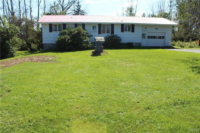 ranch-style house featuring a garage and a front lawn