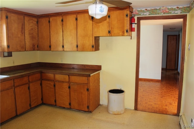 kitchen with a baseboard heating unit, light parquet floors, and ceiling fan