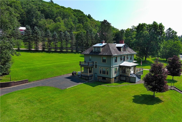 back of property featuring a yard and a gazebo