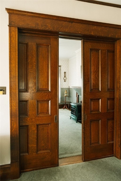 corridor with carpet floors and ornamental molding