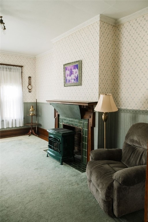 living area featuring carpet, a tile fireplace, a wood stove, and crown molding