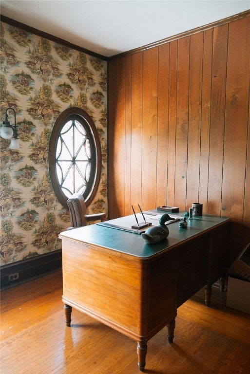 office with wooden walls and light wood-type flooring