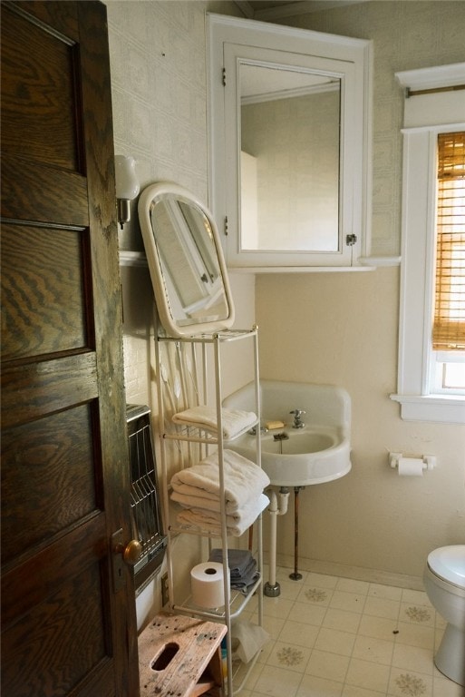 bathroom with tile floors and toilet