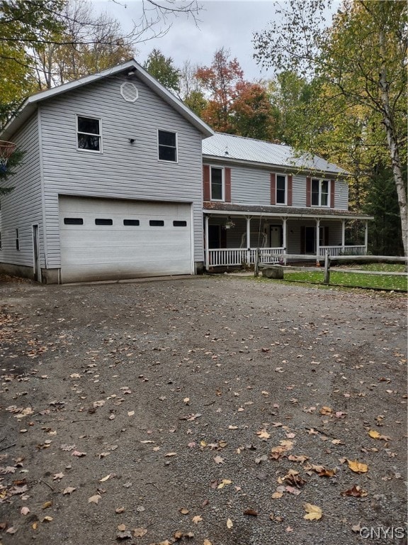 363 S Shore Rd, Webb, NY 13420 - view of front of home featuring covered porch and a garage