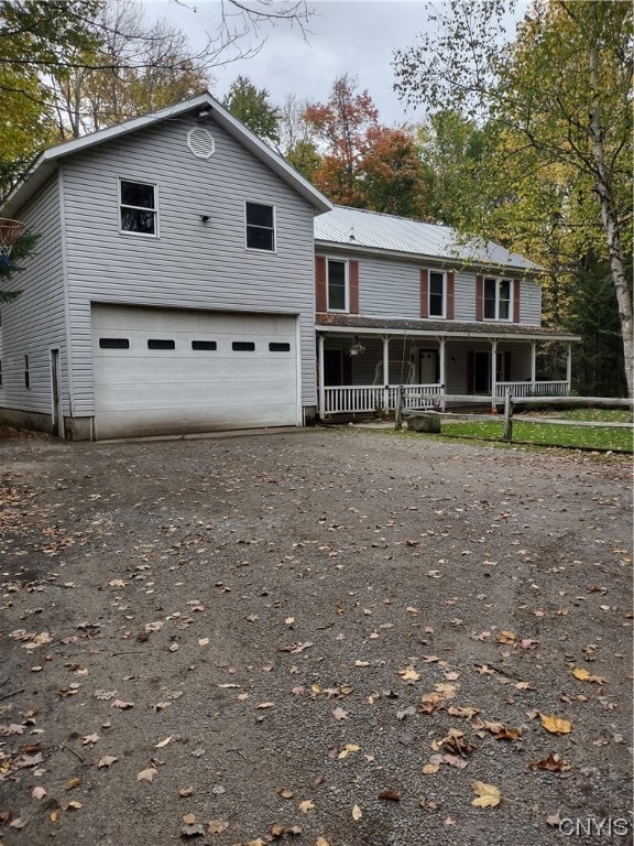 view of front of home featuring covered porch and a garage