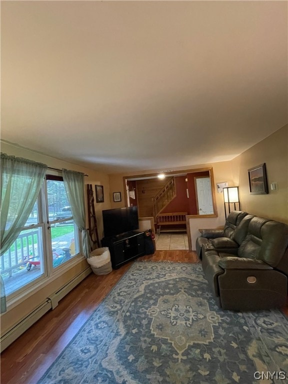 living room featuring a baseboard radiator and dark hardwood / wood-style flooring