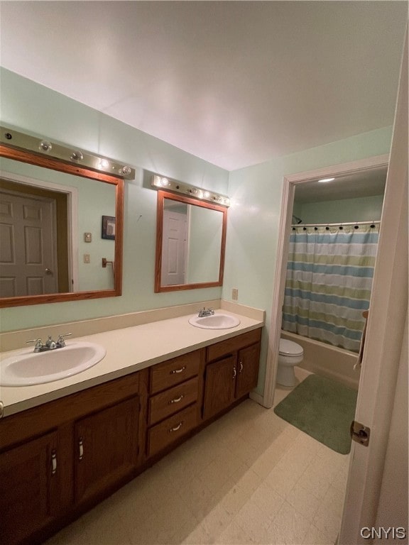 bathroom featuring toilet, tile floors, double sink, and large vanity