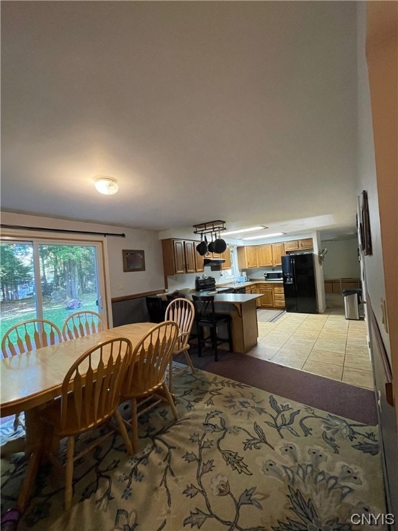 dining area featuring light tile floors