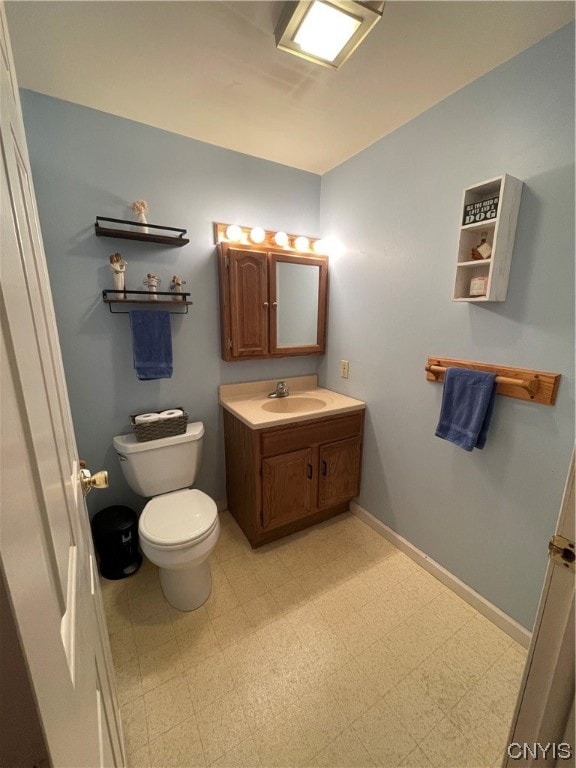 bathroom featuring toilet, tile flooring, and vanity