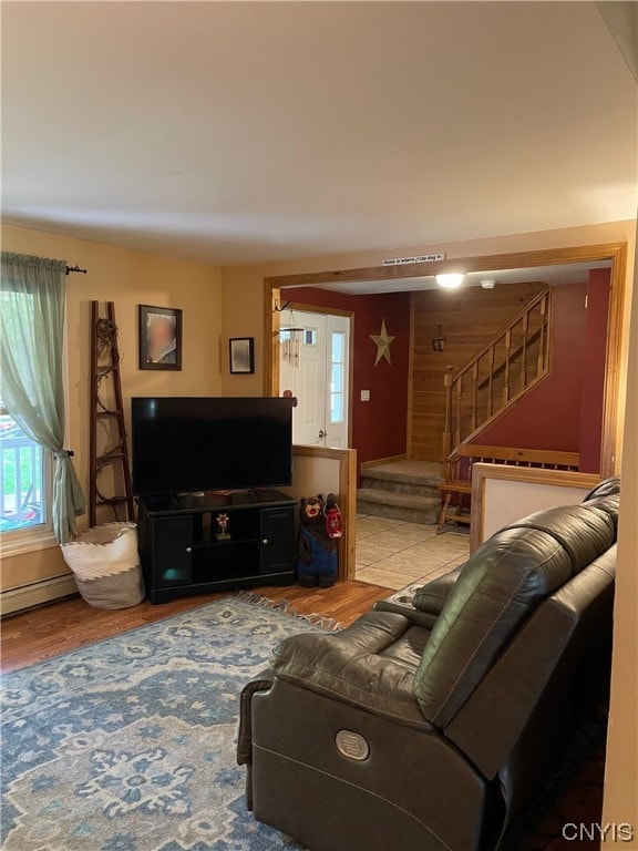 living room featuring light hardwood / wood-style floors and a baseboard heating unit