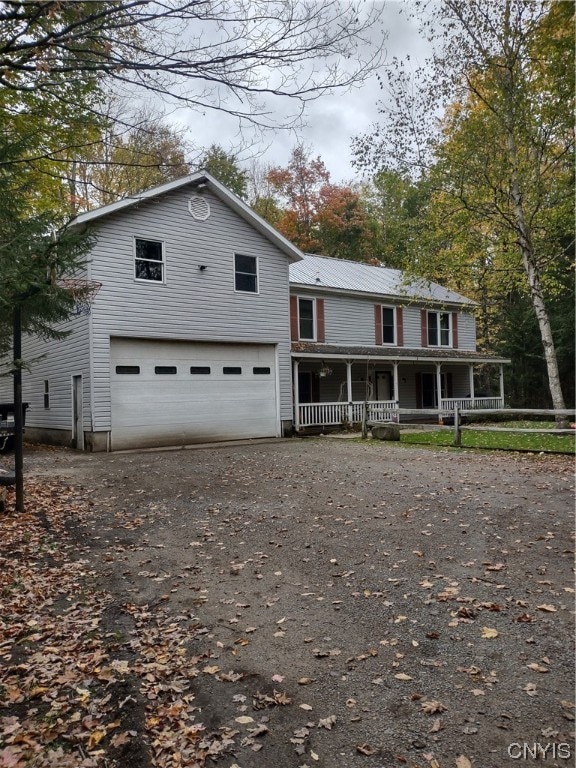 view of front facade featuring a porch and a garage