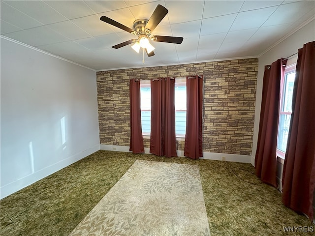 spare room with ceiling fan, ornamental molding, and carpet floors