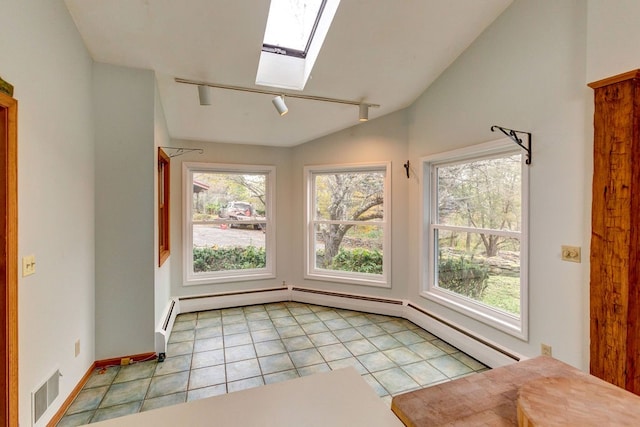 interior space featuring lofted ceiling with skylight, track lighting, and plenty of natural light