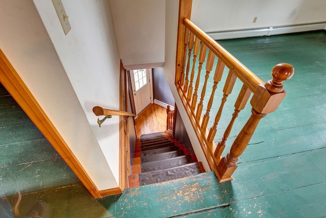 stairway with a baseboard heating unit