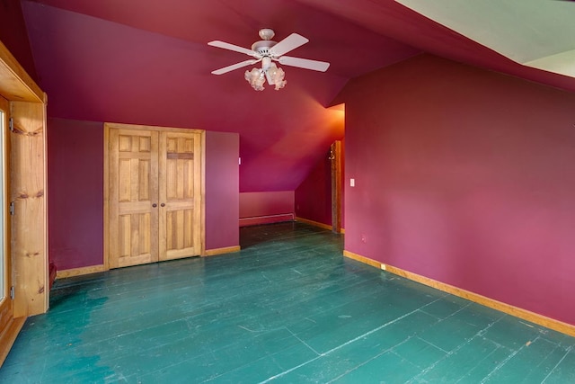 bonus room with ceiling fan, lofted ceiling, and dark wood-type flooring