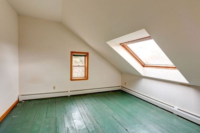 bonus room featuring lofted ceiling with skylight, a baseboard heating unit, and dark hardwood / wood-style floors