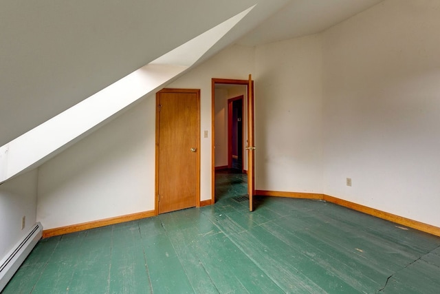 bonus room with vaulted ceiling with skylight, a baseboard radiator, and dark hardwood / wood-style flooring