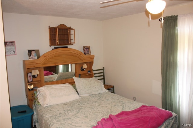 bedroom featuring a textured ceiling and ceiling fan