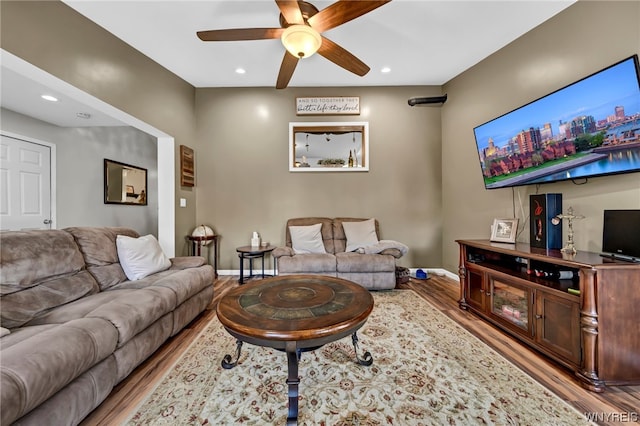 living room featuring ceiling fan and hardwood / wood-style flooring