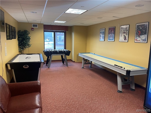 game room featuring a drop ceiling and dark colored carpet