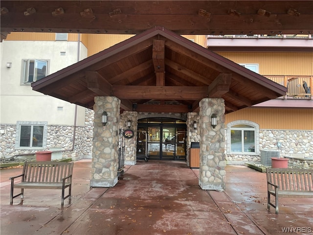 property entrance with central AC unit and a patio area