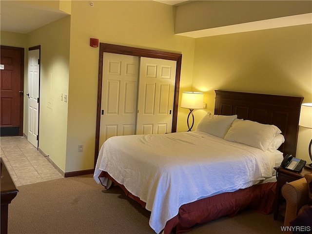 bedroom featuring a closet and light colored carpet